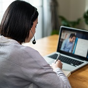 A woman with a laptop during an online training session.